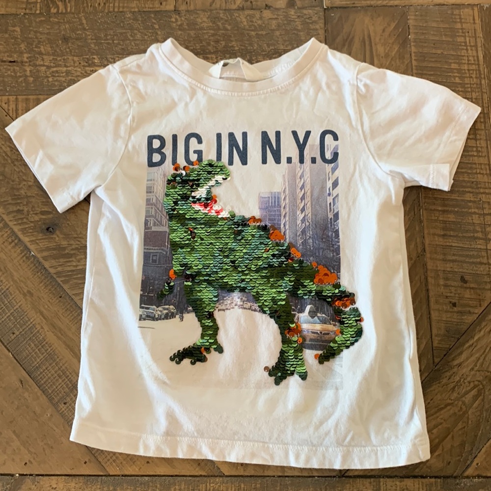 White H&M t-shirt with sequined dinosaur.